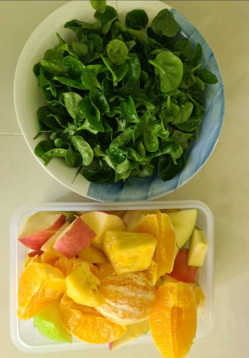 Brazilian spinach with green apple, red apple, orange and pineapple ready for a smoothie