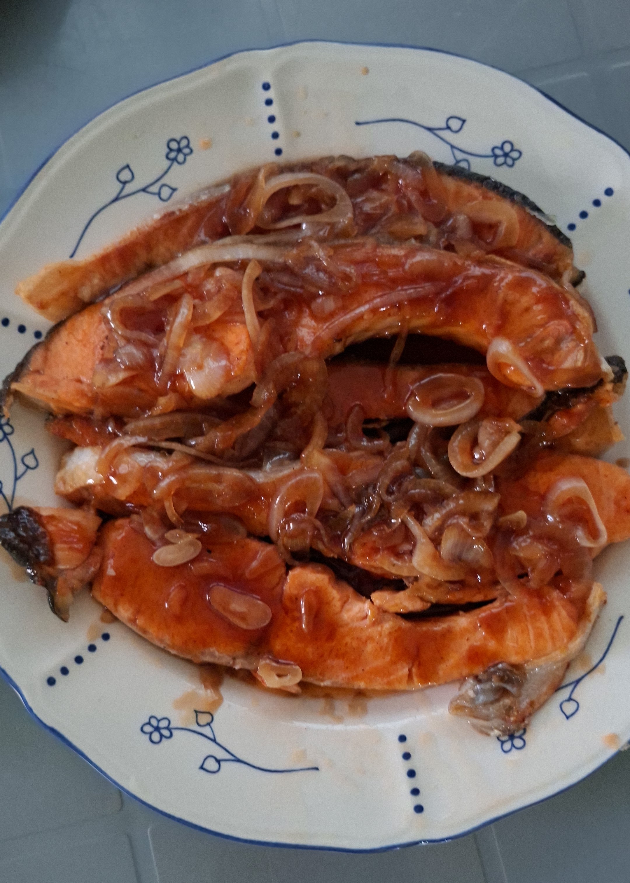 Pan-fried salmon topped with onions and teriyaki sauce
